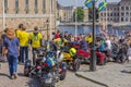 View of group of bikers on three-wheeled motorized vehicles gathering on square in front of Royal Palace