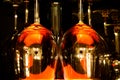 View on group of isolated red yellow shiny glowing wine glasses in cupboard