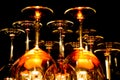 View on group of isolated red yellow shiny glowing wine glasses in cupboard