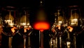 View on group of isolated red yellow shiny glowing wine glasses in cupboard