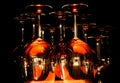 View on group of isolated red yellow shiny glowing wine glasses in cupboard