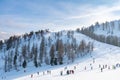 View of a group of people on a ski slope in the Dolomites against the sky. Concept for sports, landscape, people