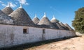 View of group of traditional trullo houses in Alberobello in the Itria Valley, Puglia Italy