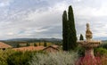 view of the guest houses and gardens of the Villa Banfi with Tuscan landscape behind