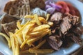 View of Gyros on a plate - traditional greek cuisine dish with kebab meat and pita bread with french fries and tzatziki sauce Royalty Free Stock Photo