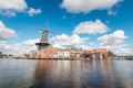 View of Haarlem city centre with the illuminated historic mill and buildings. Typical Dutch architecture