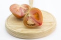 Half a split tomato raf on a wooden board Royalty Free Stock Photo