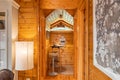 View from a hallway to a small stylish kitchen with sloping ceiling in wooden house. Translation: happiness is here, and