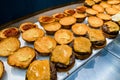 view of hamburger bun halves anointed with ketchup and mustard, served with cutlets and a slice of cheese