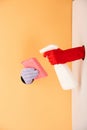 View of hands in gloves holding spray bottle and sponge on white and orange Royalty Free Stock Photo