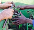 View of hands repairing old bailer