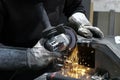 View of hands of worker grinding a piece of metal Royalty Free Stock Photo