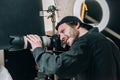 View of handsome cameraman working in photo studio