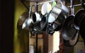 view of hanging pots, pans and kitchen utensils with bokeh effect