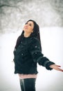 View of happy brunette girl playing with snow in winter landscape. Beautiful young female on winter background. Attractive woman Royalty Free Stock Photo