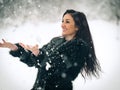 View of happy brunette girl playing with snow in winter landscape. Beautiful young female on winter background. Attractive woman Royalty Free Stock Photo