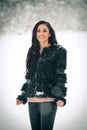 View of happy brunette girl playing with snow in winter landscape. Beautiful young female on winter background. Attractive woman Royalty Free Stock Photo