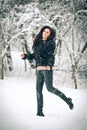 View of happy brunette girl playing with snow in winter landscape. Beautiful young female on winter background. Attractive woman Royalty Free Stock Photo