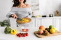 View of happy girl holding knife and cutting board Royalty Free Stock Photo