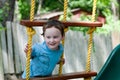 Happy little child boy climbing on the rope ladder outside Royalty Free Stock Photo