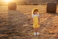 Happy girl child in yellow dress runs in autumn field Royalty Free Stock Photo