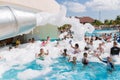 View of happy smiling joyful people relaxing and enjoying their time in swimming pool foam party on sunny day Royalty Free Stock Photo