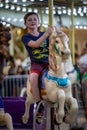 Happy young boy having fun on boardwalk amusement ride Royalty Free Stock Photo