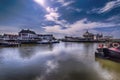 View of the harbor of Harlingen Netherlands, on a clear sunny day .To see how the cloudy clear sky reflects in the windless water