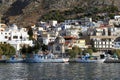 A view of the harbour with houses top on the hill and boats in front of Calymnos Island Royalty Free Stock Photo