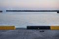 View from the harbour to white lighthouse at a seawall with wavebreakers in Seogwipo, Jeju Island, South Korea