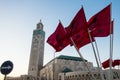 View of Hassan II mosque and a waving moroccan flags
