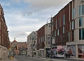 View of the headrow in Leeds with victoria quarter shops and people getting on a bus