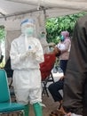 The view of a health worker conducting a PCR test on residents at the Jakarta Health Center, East Jakarta 2021