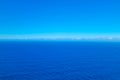 View from a height on the blue background of the sky and ocean or sea. Background water. Royalty Free Stock Photo