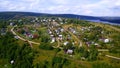 View from the height . Clip . A small summer village with a river, small residential houses and roads, a green forest Royalty Free Stock Photo