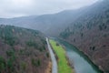 A view from a height of the mountains and the forest, the road in the mountains, the river near road. Fog in mountains. Royalty Free Stock Photo