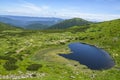 View from the height, to Alpine lake Nesamovyte under hill among a green mountains of Chornohora Ridge, Ukraine Royalty Free Stock Photo