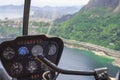 View from a helicopter cockpit flying over Rio de Janeiro. Cockpit with instruments panel. Captain in the aircraft cockpit.