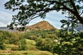 View of Helm Crag, framed within leafy branches