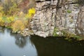 View of the high cliffs of the canyon. River and rocks. Autumn leaves fall in the river