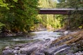 View of a high logging road bridge from the beautiful river beneath the bridge on a fall day.