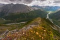 View from a high mountain range to a green valley with a river. Royalty Free Stock Photo