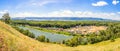 View from a high mountain to the tourist festival glade on a summer sunny day against the background Royalty Free Stock Photo