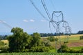 View of high power poles with electric wires in agricultural landscape in South Moravia under summer blue sky Royalty Free Stock Photo