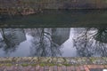 View of high rise blocks of flats in Birmingham City Centre, reflected in the water of the canal on a cold winter`s day.