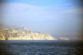 View of the high and steep rock face of the badlands on the Mediterranean sea, under a hazy sky, Parc National des Calanques, Mars Royalty Free Stock Photo