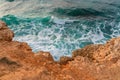 View from the high stone shore of the sea foaming waves and fantastic rocky coast