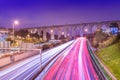 View of highway with car traffic and light trails. The Aguas Livres Aqueduct Aqueduto das ÃÂguas Livres in Lisbon, Portugal