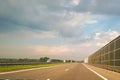 A view of the highway from the perspective of the driver and passenger. Dry asphalt, energy-intensive barriers and sky