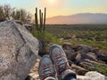 View of hiking boots Saguaro cactus mountains and a valley from top of ridge Royalty Free Stock Photo